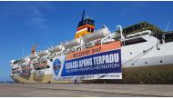 A giant banner reading 'Recovery Ship: Integrated Floating Isolation - Recovery, Training, Recreation' is seen on a passenger ship owned by the state-owned shipping company PT PELNI, KM Umsini, which has been modified as an isolation centre for the corona