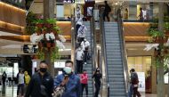 People wearing protective face masks walk at the Pondok Indah shopping mall, as the Indonesian capital reopens shopping malls with a new policy requiring shoppers to show a coronavirus disease (COVID-19) vaccination certificate, in Jakarta, Indonesia, Aug