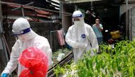 Buddhist monks wear personal protective equipment (PPE) as they perform coronavirus disease (COVID-19) testing in a community near their temple in Bangkok, Thailand August 4, 2021. Picture taken August 4, 2021. REUTERS/Soe Zeya Tun