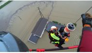 A Saga prefectural rescue worker lifting up a resident to a helicopter from submerged house caused by heavy rain during a rescue operation in Takeo, Saga Prefecture, southwestern Japan, in this handout image taken on August 14, 2021, and released by Saga 