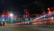 Traffic moves in front of the Chhatrapati Shivaji Maharaj Terminus (CSMT) building as it is illuminated in the colours of India's national flag on the eve of the 75th Independence Day in Mumbai, India, August 14, 2021. Reuters/Francis Mascarenhas