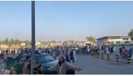 A horde of people run towards the Kabul Airport Terminal, after Taliban insurgents took control of the presidential palace in Kabul, August 16, 2021, in this still image taken from video obtained from social media. Jawad Sukhanyar/via Reuters