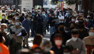People wait in line outside a coronavirus disease (COVID-19) vaccination centre at Sydney Olympic Park during a lockdown to curb the spread of an outbreak in Sydney, Australia, August 16, 2021. REUTERS/Loren Elliott