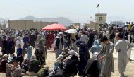 People wait outside Hamid Karzai International Airport in Kabul, Afghanistan August 17, 2021. REUTERS