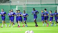 Al Duhail players warm up during a training session.
