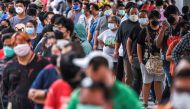 FILE PHOTO: People wearing protective masks queue outside the Central Vaccination Center as Thailand opens walk-in first dose of the AstraZeneca coronavirus disease (COVID-19) vaccination scheme for elders, people with a minimum weight of 100 kilograms an