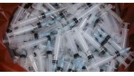 FILE PHOTO: Used syringes lie discarded in a bin after they were used to administer the coronavirus disease (COVID-19) vaccine in Mumbai, India, August 11, 2021. REUTERS/Francis Mascarenhas


