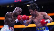 Manny Pacquiao (right) fights Yordenis Ugas in a world welterweight championship bout at T-Mobile Arena. Stephen R. Sylvanie-USA TODAY Sports