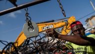 A man working at a metal recycler weights metal scavenged from houses destroyed after last week's 7.2 magnitude quake in Les Cayes, Haiti August 21, 2021. REUTERS/Ricardo Arduengo