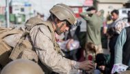 A US Marine opens a meal ready-to-eat for children to eat during an evacuation at Hamid Karzai International Airport, Kabul, Afghanistan. US Marine Corps/Sgt. Samuel Ruiz/Handout via Reuters