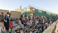 Crowds of people wait outside the airport in Kabul, Afghanistan August 25, 2021 in this picture obtained from social media. Twitter/DAVID_MARTINON via REUTERS 