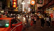 FILE PHOTO: A woman wearing a protective face mask enters a taxi in Chinatown, after the government started opening some restaurants outside shopping malls, parks, and barbershops during the coronavirus disease (COVID-19) outbreak in Bangkok, Thailand, Ma