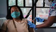 A person receives a dose of the Pfizer-BioNTech vaccine for the coronavirus disease (COVID-19), at a mobile inoculation site in the Bronx borough of New York City, New York, U.S., August 18, 2021. REUTERS/David 'Dee' Delgado/File Photo