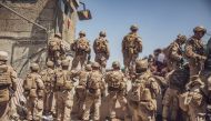 U.S. Marines with Special Purpose Marine Air-Ground Task Force - Crisis Response - Central Command assist with security at an Evacuation Control Checkpoint (ECC) during an evacuation at Hamid Karzai International Airport, Kabul, Afghanistan, August 26, 20