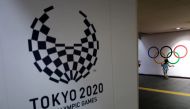 A girl runs past Olympic rings and the logo of Tokyo 2020 Paralympic Games amid the coronavirus disease (COVID-19) pandemic in Tokyo, Japan, August 16, 2021. REUTERS/Athit Perawongmetha