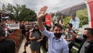 FILE PHOTO: Canada's Liberal Prime Minister Justin Trudeau waves during his election campaign tour in Nobleton, Ontario, Canada August 27, 2021. REUTERS/Carlos Osorio/File Photo
