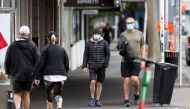 People wear masks as they exercise during a lockdown to curb the spread of a coronavirus disease (COVID-19) outbreak, in Auckland, New Zealand, August 26, 2021. REUTERS/Fiona Goodall