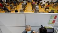 A man receives his vaccination at a coronavirus disease (COVID-19) vaccination center in Singapore March 8, 2021. REUTERS/Edgar Su/File Photo