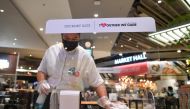 A staff member prepares to open a restaurant on the first day of coronavirus restrictions lift on retail and dining in Bangkok and other high-risk areas to revive the economy, as the country battles its worst coronavirus disease (COVID-19) outbreak, in Ba