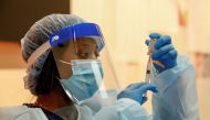 Medical assistant Mariasha Davis draws the Moderna COVID-19 vaccine into a syringe before people are inoculated at Trinity United Church of Christ in Chicago, Illinois, U.S., February 13, 2021. REUTERS/Kamil Krzaczynski/File Photo