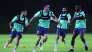 Qatar SC players in action during a practice session on the eve of their match.