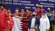 Khalil Ahmad Al Mohannadi, President of the Arab Table Tennis Federation, poses for a photograph with an official and the Qatar U-13 team members and coaches after presenting the medals to the winners in Amman, Jordan. Both Qatar U-13 and U-11 teams were 