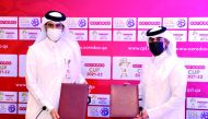 Qatar Stars League's (QSL) Executive Director of Sales, Marketing and Communication, Hassan Rabia Al Kuwari exchanges documents with Executive Director Business at Ooredoo, Thani Al Malki, during a sponsorship signing ceremony held in Doha. QSL and Ooredo