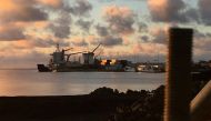 FILE PHOTO: A container ship unloads at the Matautu port, which has been expanded through support from Japan, in the Samoan capital of Apia, July 12, 2019. Picture taken July 12, 2019. REUTERS/Jonathan Barrett/File Photo