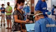 Swab tests are conducted at a public housing estate after a nearby food centre became a coronavirus disease (COVID-19) cluster, in Singapore, June 16, 2021. REUTERS/Caroline Chia/File Photo