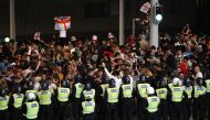 FILE PHOTO: Soccer Football - Euro 2020 - Final - Fans gather for Italy v England - Wembley Stadium, London, Britain - July 11, 2021 Police officers stand guard as England fans gather outside Wembley Stadium during the match Action Images via Reuters/Pete