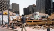 Workers clean up the site of the Historic Karnofsky Shop, a historic building, that collapsed during Hurricane Ida in New Orleans, Louisiana, U.S., September 6, 2021. REUTERS/Kathleen Flynn