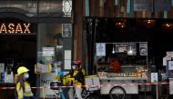 (From L) A construction worker, delivery courier and restaurant staff wear protective face masks while working in the city centre during a lockdown to curb the spread of a coronavirus disease (COVID-19) outbreak in Sydney, Australia, September 9, 2021. RE