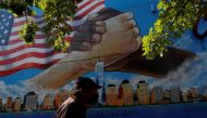 A man walks by a 9/11 memorial mural in the Bronx borough of New York City, U.S., September 10, 2021. REUTERS/Shannon Stapleton
