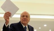 Lebanon's Prime Minister Najib Mikati holds the cabinet line up after meeting with Lebanon's President Michel Aoun at the presidential palace in Baabda, Lebanon September 10, 2021. REUTERS/Mohamed Azakir