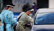A medical worker administers a COVID-19 test at a testing clinic during a lockdown to curb the spread of a coronavirus disease (COVID-19) outbreak in Auckland, New Zealand, August 26, 2021. REUTERS/Fiona Goodall