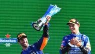 McLaren's Daniel Ricciardo celebrates with the trophy on the podium with after winning the race alongside second place McLaren's Lando Norris REUTERS/Jennifer Lorenzini
