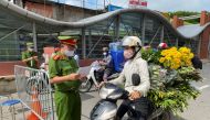 Vietnam police officers inspect authorised travel documents of commuters at a check point during the first day of the extended lockdown in Hanoi, Vietnam, September 6, 2021. REUTERS/Stringer/File Photo