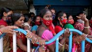Women wait to receive a dose of COVISHIELD vaccine, a coronavirus disease (COVID-19) vaccine manufactured by Serum Institute of India, outside a vaccination centre in Kolkata, India, August 31, 2021. REUTERS/Rupak De Chowdhuri/File Photo