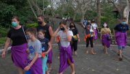People wear protective face masks on the first day of trial opening for tourist attractions amid the coronavirus disease (COVID-19) outbreak in Badung, Bali, Indonesia September 13, 2021, in this photo taken by Antara Foto/Nyoman Hendra Wibowo/via REUTERS