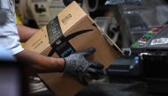 A worker assembles a box for delivery at the Amazon fulfillment center in Baltimore, Maryland, U.S., April 30, 2019. REUTERS/Clodagh Kilcoyne/File Photo