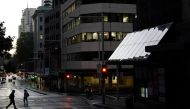 Pedestrians cross an intersection in the city centre during a lockdown to curb the spread of a coronavirus disease (COVID-19) outbreak in Sydney, Australia, September 14, 2021. REUTERS/Loren Elliott