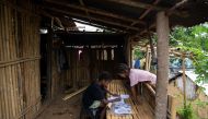 Seventh grade student Ryza Delos Santos, 10, works on her modules at home as her cousin observes, after a session at the makeshift rickshaw distance learning center for the Aeta community in Porac, Pampanga, Philippines, October 12, 2020. Picture taken Oc
