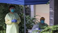 Health workers provide coronavirus disease (COVID-19) testing to residents of surrounding public housing towers in the Redfern suburb, where authorities are working to contain an emerging cluster of cases, as a widespread lockdown continues in Sydney, Aus