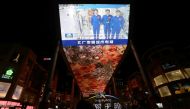 A giant screen shows a news broadcast of the astronauts of the Shenzhou-12 mission inside the core module Tianhe of the Chinese Space station, before returning to Earth, in Beijing, China September 16, 2021. REUTERS/Tingshu Wang