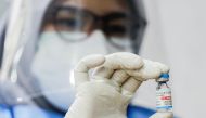 FILE PHOTO: A healthcare worker shows a dose of Sinopharm vaccine against the coronavirus disease (COVID-19) during a mass vaccination program for foreigners in Jakarta, Indonesia, August 24, 2021. REUTERS/Ajeng Dinar Ulfiana/File Photo
