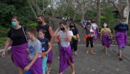 People wear protective face masks on the first day of trial opening for tourist attractions amid the coronavirus disease (COVID-19) outbreak in Badung, Bali, Indonesia September 13, 2021, in this photo taken by Antara Foto/Nyoman Hendra Wibowo/via REUTERS