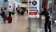 File photo: A worker sanitises a sign at the International arrivals area of Terminal 5 in London's Heathrow Airport, Britain, August 2, 2021. Reuters/Peter Nicholls/File Photo