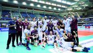 Qatar players and officials celebrate after defeating Australia in straight sets yesterday.