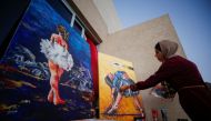 A Palestinian artist, Abeer Jibril, works on ballet paintings at her home in Gaza City, September 8, 2021. Reuters/Mohammed Salem