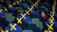 Visitors wearing protective masks watch a movie at a cinema as it is reopened after the ease of restrictions amid the coronavirus disease (COVID-19) pandemic in Jakarta, Indonesia, September 16, 2021. REUTERS/Willy Kurniawan/File Photo